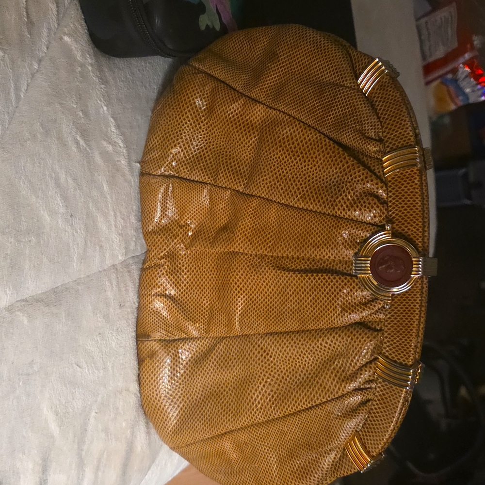 This vintage Judith Leiber snake skin leather handbag is a must have.